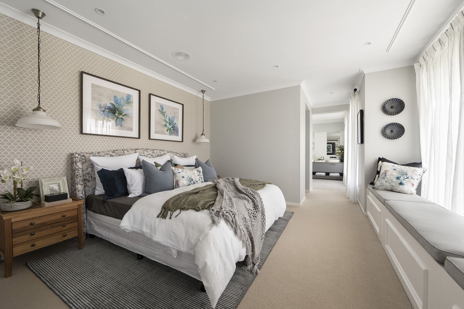 modern country home design master bedroom with built in bench seat under window and tufted headboard